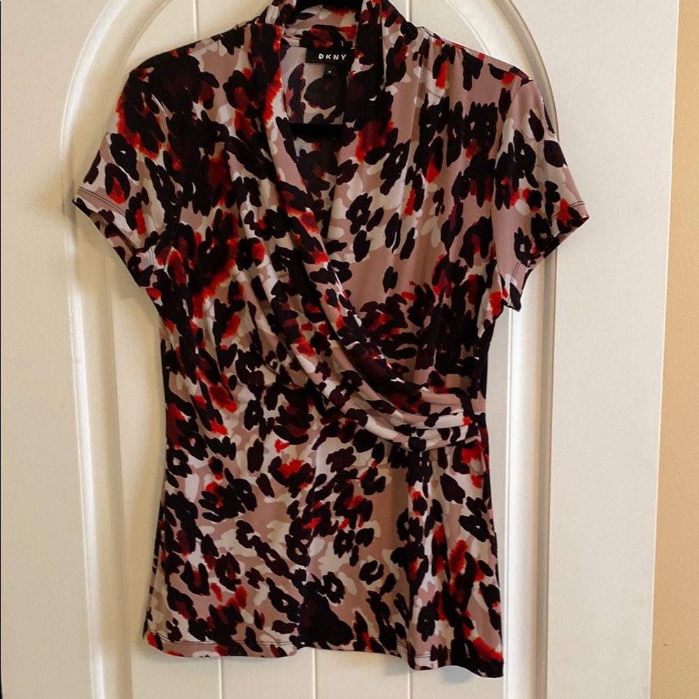 DKNY Black and White Wrap Blouse with Notched Collar and Fitted Style
